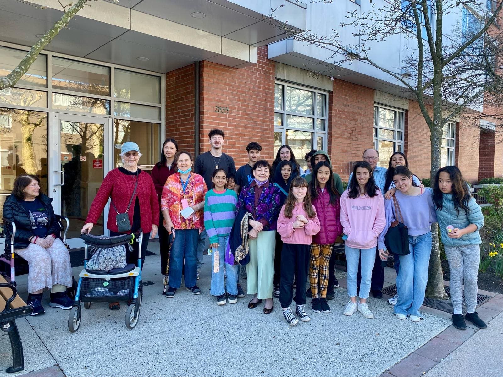 A junior youth group visiting neighbours at a local residence during a service project.
